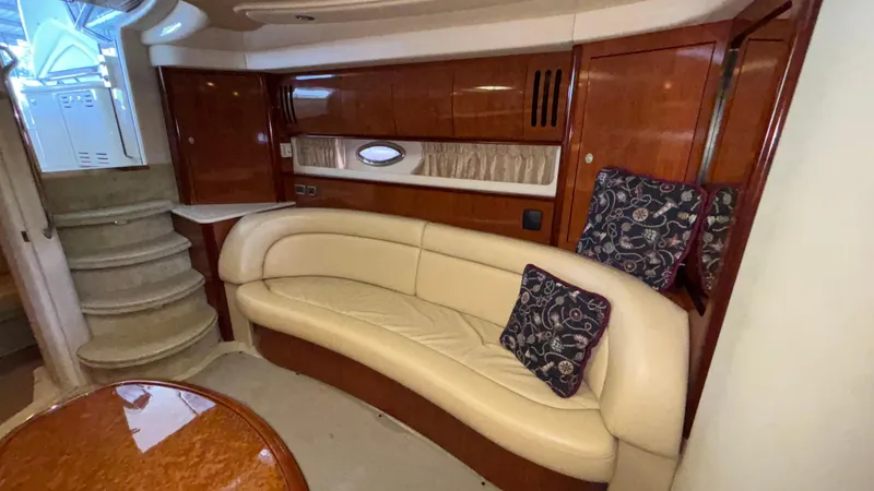 Yacht Photos Pics Interior of 2004 Sea Ray 420 Sundancer with curved leather seating and wooden cabinetry.