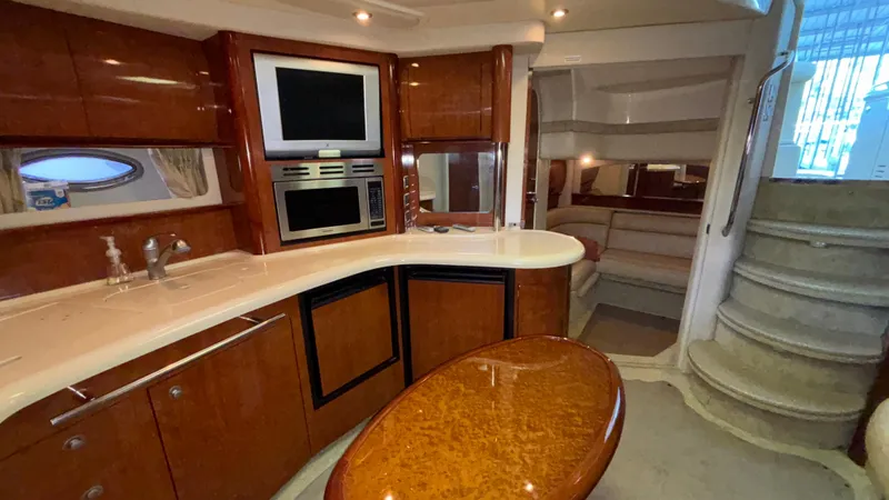  Yacht Photos Pics Luxurious interior of 2004 Sea Ray 420 Sundancer yacht with modern kitchen and seating area.