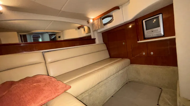  Yacht Photos Pics Interior of 2004 Sea Ray 420 Sundancer yacht with beige seating and built-in TV.