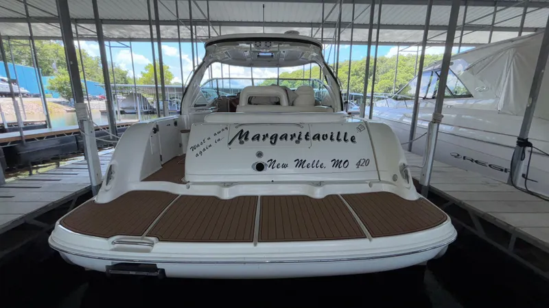  Yacht Photos Pics 2004 Sea Ray 420 Sundancer docked, rear view with "Margaritaville" name, in covered marina.