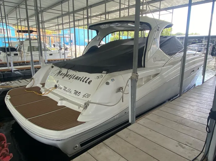  Yacht Photos Pics 2004 Sea Ray 420 Sundancer docked in a covered marina slip.