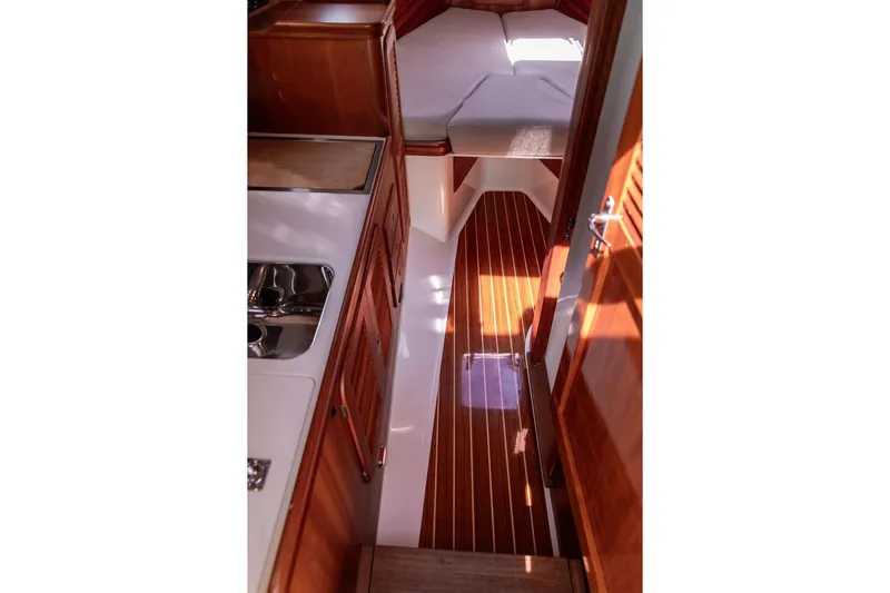 Admiralty Yacht Photos Pics Interior of 2005 Hinckley Picnic Boat EP, featuring wood paneling and compact cabin space.