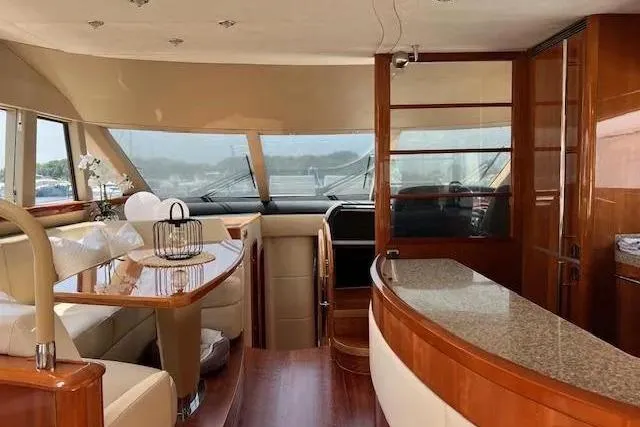  Yacht Photos Pics Luxurious interior of 2006 Princess 67 Flybridge Motor Yacht with elegant wood finishes.