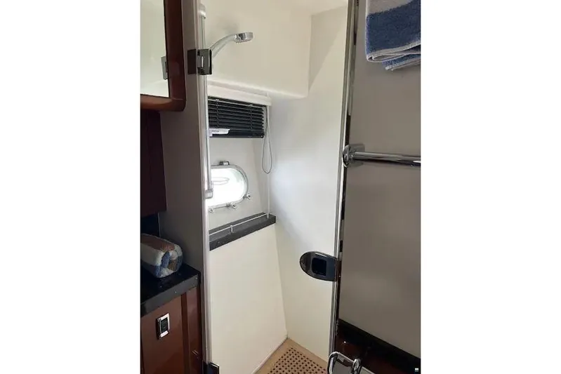  Yacht Photos Pics Bathroom interior of 2006 Princess 67 Flybridge Motor Yacht with shower and porthole window.