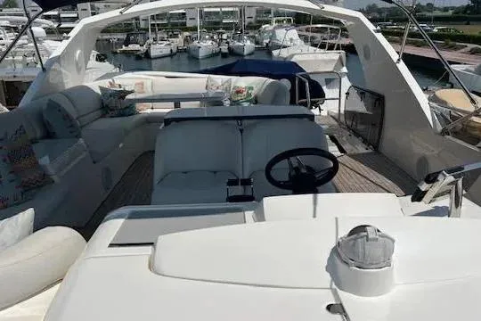  Yacht Photos Pics 2006 Princess 67 Flybridge Motor Yacht with spacious seating and helm, docked at marina.