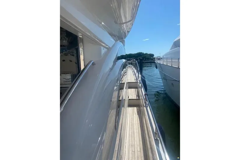  Yacht Photos Pics Side view of 2006 Princess 67 Flybridge Motor Yacht docked by the water.