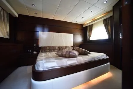  Yacht Photos Pics Luxurious bedroom interior on 2008 Tecnomar NADARA 80 flybridge yacht, featuring elegant wood paneling.