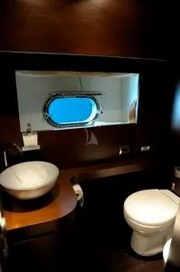  Yacht Photos Pics Luxurious Tecnomar NADARA 80 yacht bathroom with modern fixtures and porthole view.