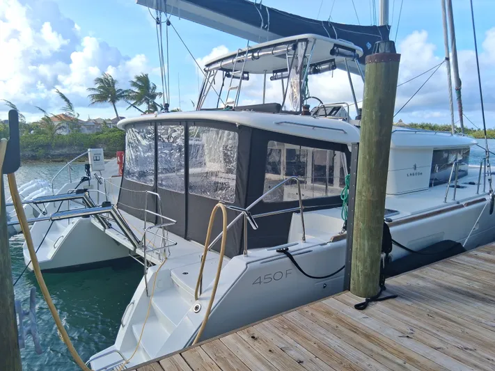 Paper Doll Yacht Photos Pics 2019 Lagoon 450 F catamaran docked, featuring sleek design and spacious deck.