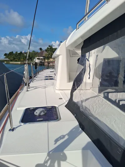 Paper Doll Yacht Photos Pics 2019 Lagoon 450 F catamaran deck with clear skies and waterfront view.