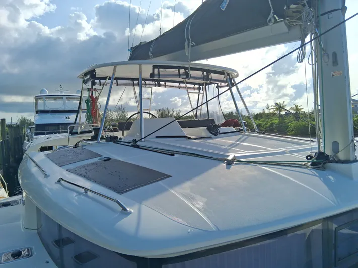 Paper Doll Yacht Photos Pics 2019 Lagoon 450 F catamaran docked under a cloudy sky.
