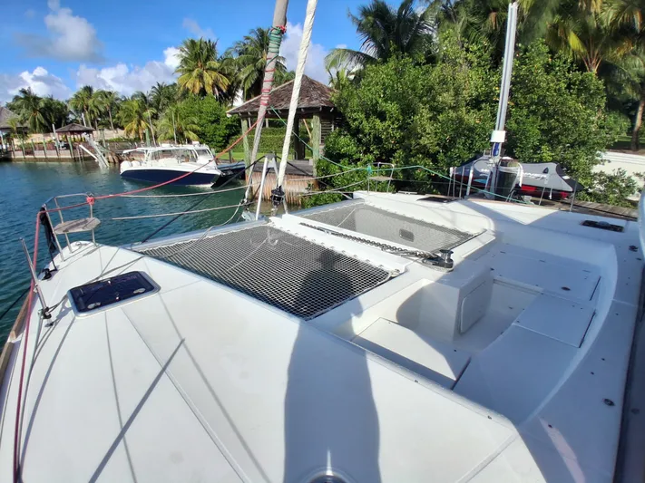 Paper Doll Yacht Photos Pics Lagoon 450 F catamaran docked by tropical waterfront, 2019 model.