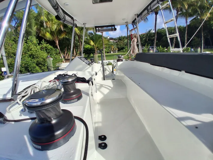 Paper Doll Yacht Photos Pics 2019 Lagoon 450 F catamaran deck with winches and tropical backdrop.