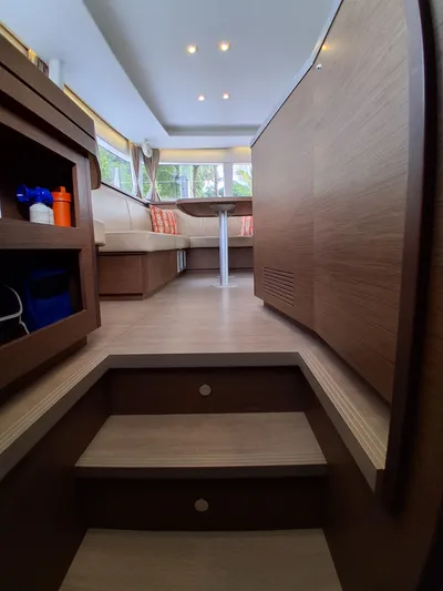 Paper Doll Yacht Photos Pics Interior of 2019 Lagoon 450 F catamaran with modern wood finish and cozy seating area.