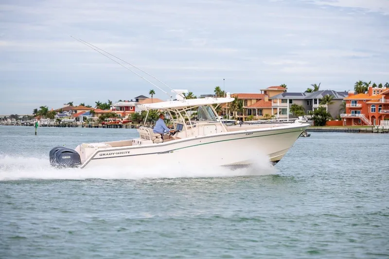  Yacht Photos Pics 2014 Grady-White Canyon 336 boat cruising near waterfront homes.