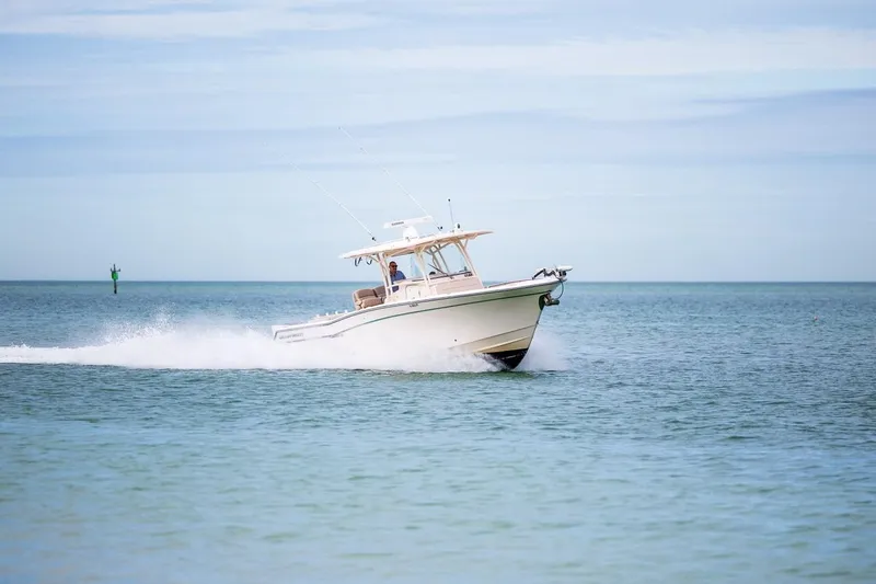  Yacht Photos Pics 2014 Grady-White Canyon 336 boat cruising on open water.