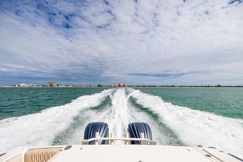  Yacht Photos Pics 2014 Grady-White Canyon 336 cruising on open water under a cloudy sky.