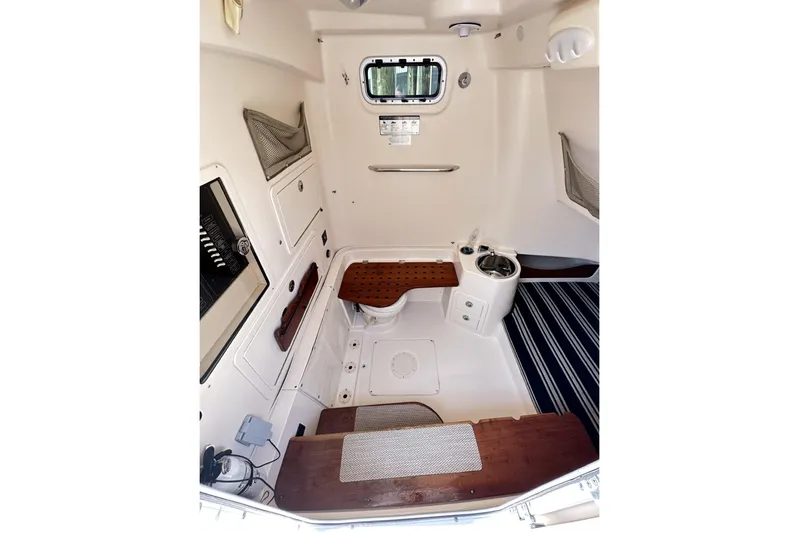  Yacht Photos Pics 2014 Grady-White Canyon 336 cabin interior with compact amenities and wooden accents.