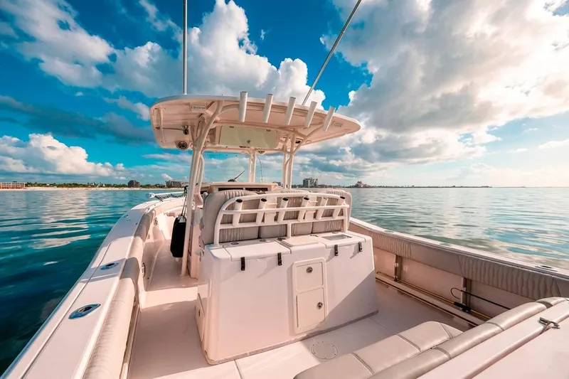  Yacht Photos Pics 2014 Grady-White Canyon 336 boat on calm water under a vibrant sky.