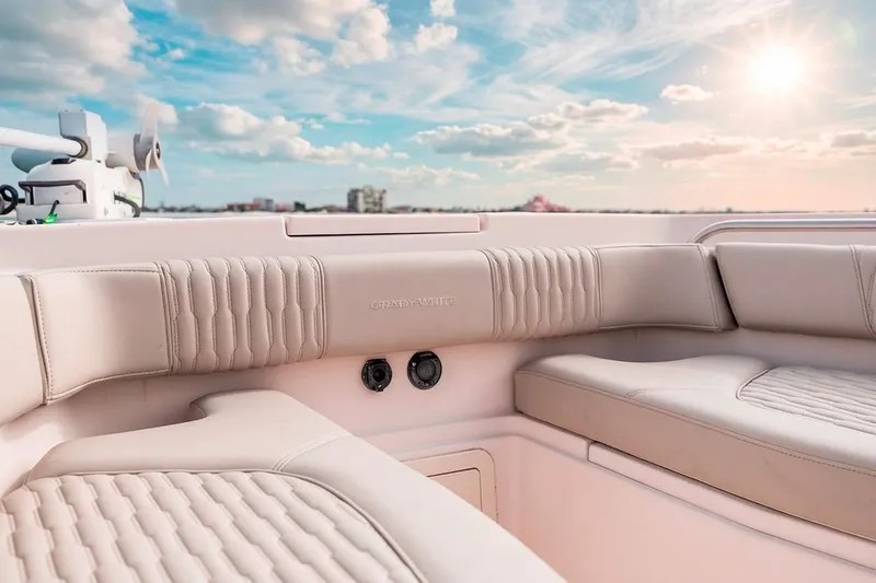  Yacht Photos Pics 2014 Grady-White Canyon 336 boat interior with plush seating under a sunny sky.