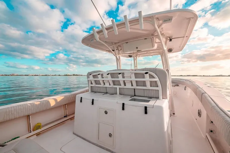  Yacht Photos Pics 2014 Grady-White Canyon 336 boat on calm water under a vibrant sky.