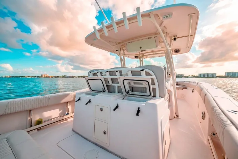  Yacht Photos Pics 2014 Grady-White Canyon 336 boat on calm water under a vibrant sky.