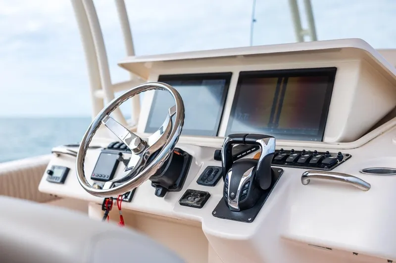  Yacht Photos Pics 2014 Grady-White Canyon 336 boat dashboard with steering wheel and controls.
