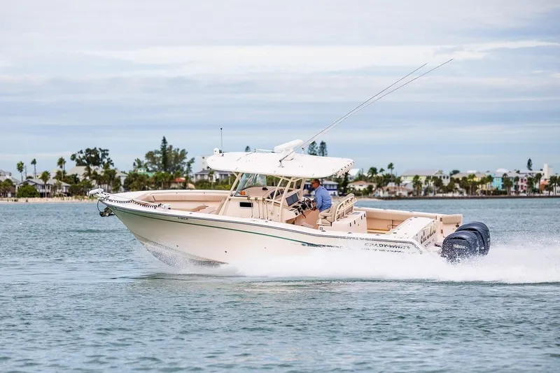  Yacht Photos Pics 2014 Grady-White Canyon 336 boat cruising on water, showcasing sleek design and powerful engines.
