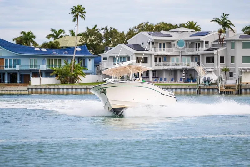  Yacht Photos Pics 2014 Grady-White Canyon 336 boat cruising near waterfront homes.