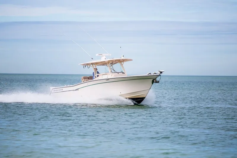  Yacht Photos Pics 2014 Grady-White Canyon 336 boat cruising on open water.