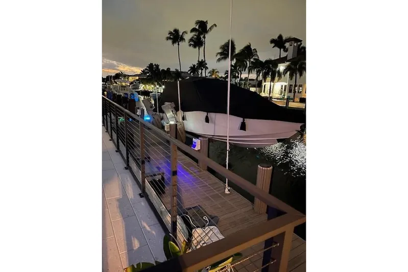  Yacht Photos Pics 2019 Nor-Tech 390 Sport Center Console docked at night, surrounded by palm trees.