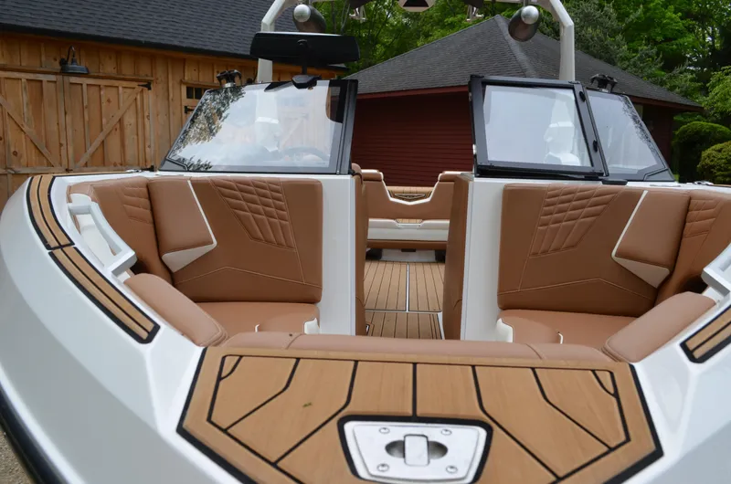 Yacht Photos Pics 2023 Nautique Super Air Nautique S23 interior with tan seating and wood accents.