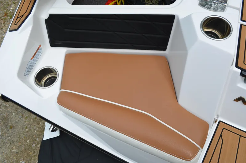  Yacht Photos Pics 2023 Nautique Super Air Nautique S23 boat seat with tan upholstery and cup holders.