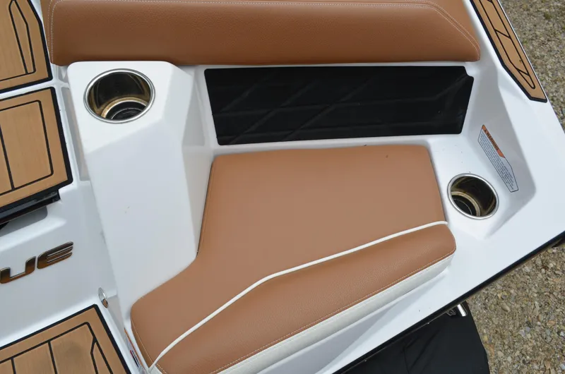  Yacht Photos Pics 2023 Nautique Super Air Nautique S23 boat interior with tan seating and cup holders.