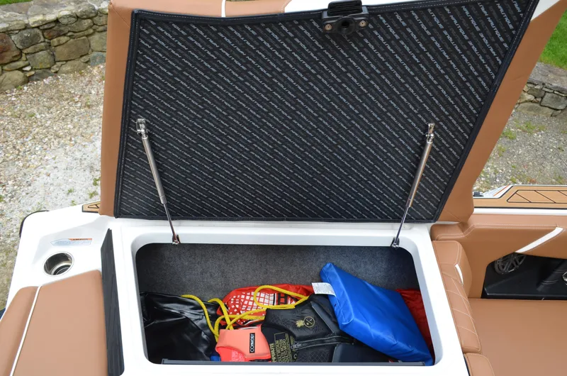  Yacht Photos Pics Open storage compartment in 2023 Nautique Super Air Nautique S23 boat with gear inside.