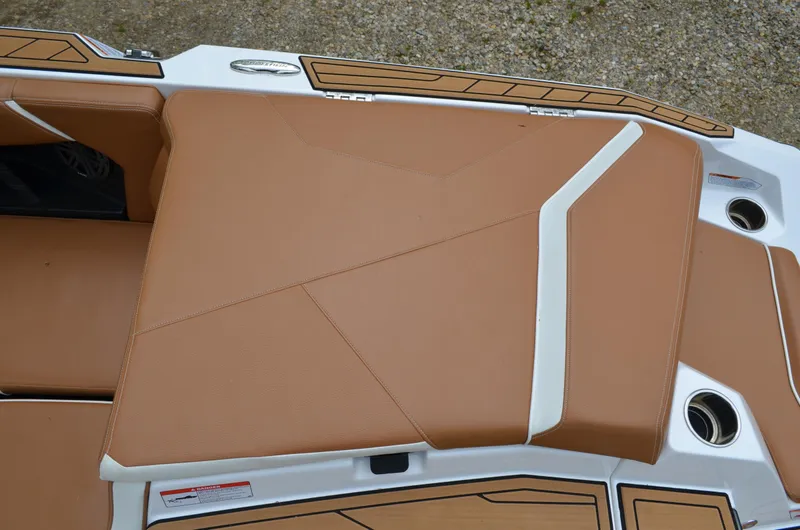  Yacht Photos Pics 2023 Nautique Super Air Nautique S23 boat seating with tan upholstery and white accents.