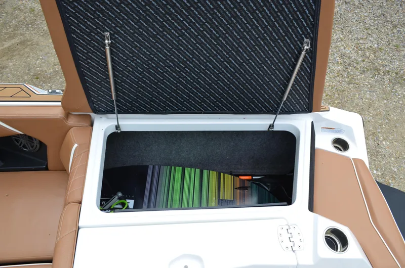  Yacht Photos Pics 2023 Nautique Super Air Nautique S23 storage compartment with open lid and colorful interior.