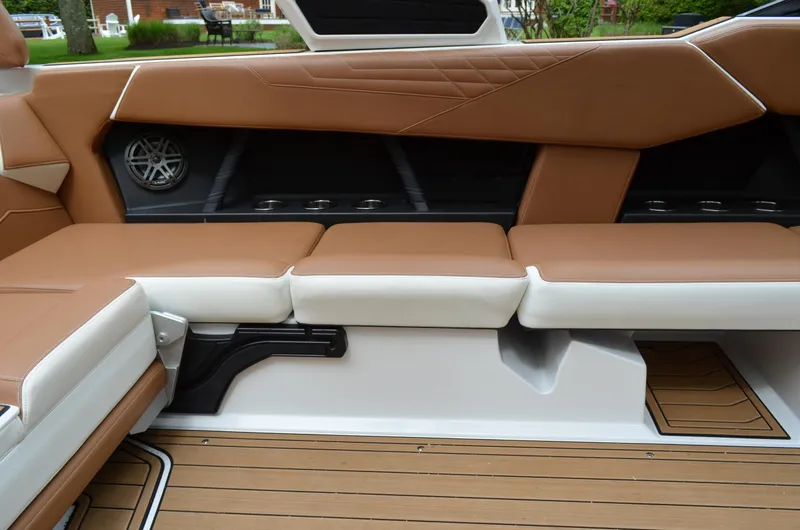 Yacht Photos Pics 2023 Nautique Super Air Nautique S23 interior with tan and white seating.