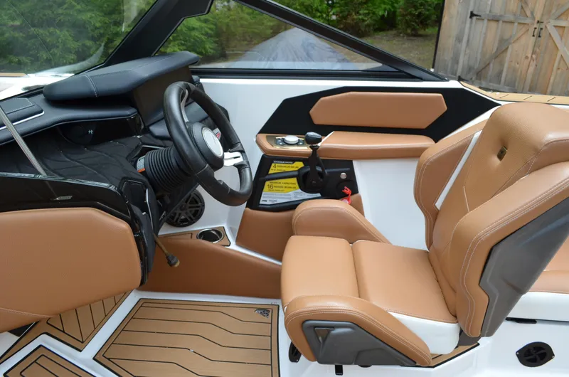  Yacht Photos Pics 2023 Nautique Super Air Nautique S23 interior with tan leather seats and modern dashboard.