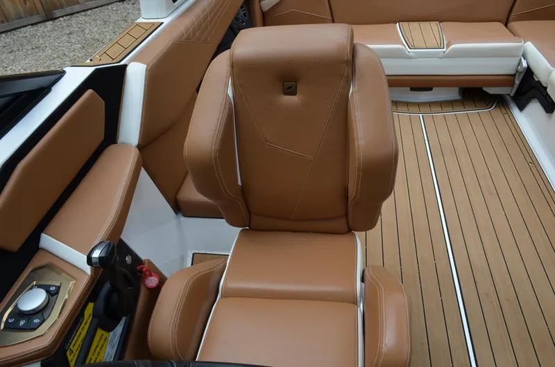 Yacht Photos Pics 2023 Nautique Super Air Nautique S23 interior with tan leather seating and modern controls.