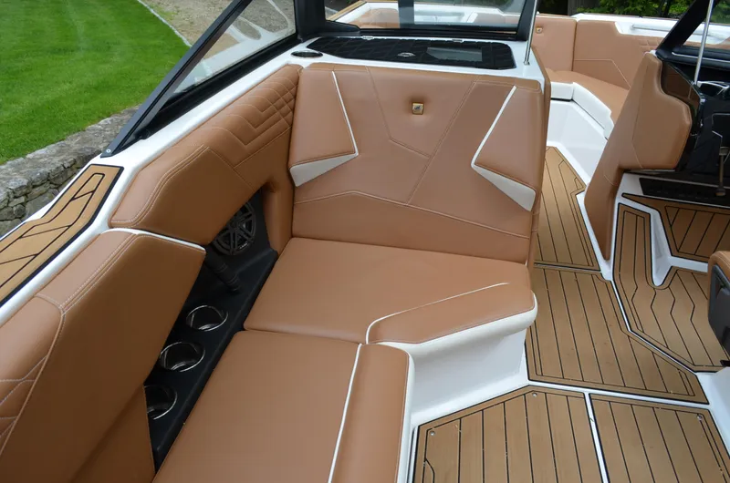  Yacht Photos Pics 2023 Nautique Super Air Nautique S23 interior with tan seating and teak flooring.