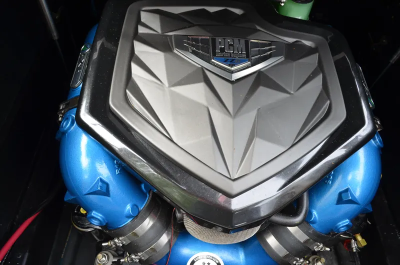  Yacht Photos Pics 2023 Nautique Super Air Nautique S23 engine with PCM cover, featuring blue components.