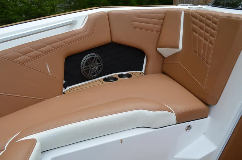  Yacht Photos Pics 2023 Nautique Super Air Nautique S23 interior with tan upholstery and cup holders.