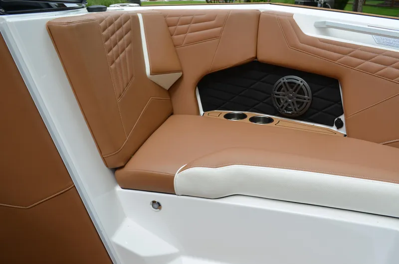  Yacht Photos Pics 2023 Nautique Super Air Nautique S23 interior with brown leather seats and speaker detail.