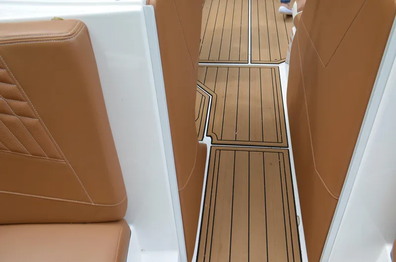  Yacht Photos Pics 2023 Nautique Super Air Nautique S23 interior with tan seating and teak-style flooring.
