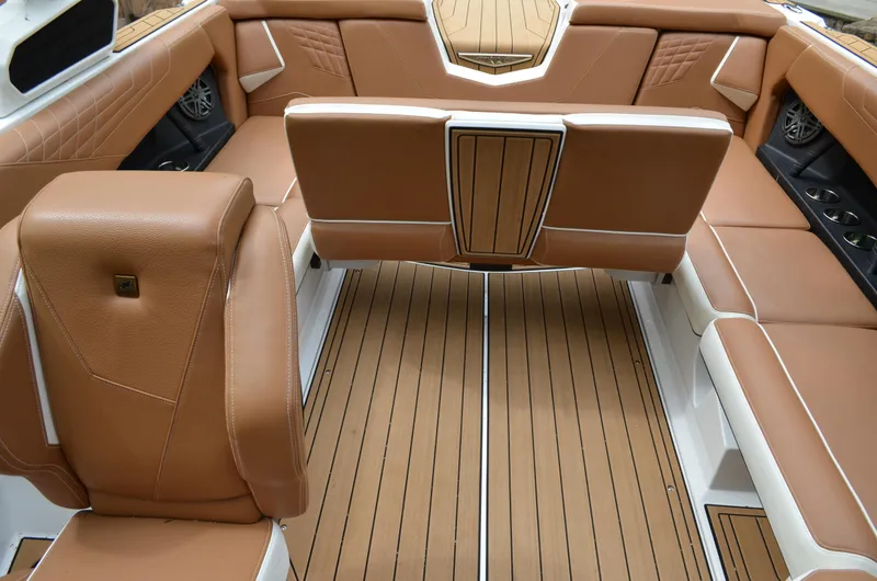  Yacht Photos Pics 2023 Nautique Super Air Nautique S23 interior with tan leather seating and wood-style flooring.