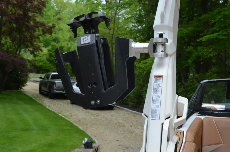  Yacht Photos Pics 2023 Nautique Super Air Nautique S23 wakeboard rack detail in a lush outdoor setting.