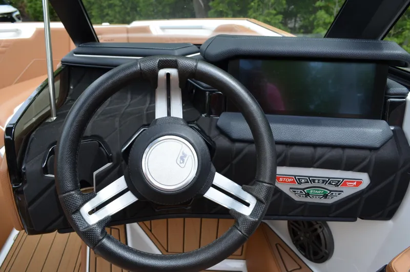  Yacht Photos Pics 2023 Nautique Super Air Nautique S23 dashboard with steering wheel and control panel.