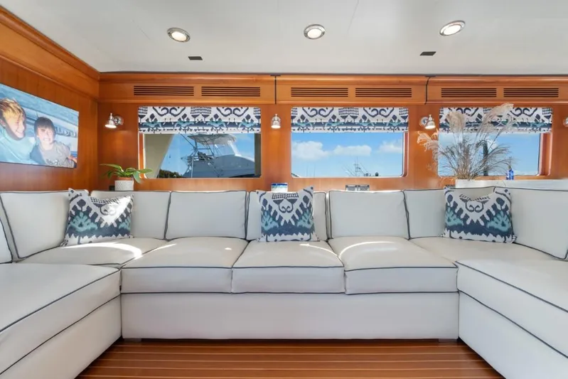 Pivot Yacht Photos Pics Luxurious interior of 2013 Marlow Explorer Enclosed Bridge yacht with white sectional sofa.