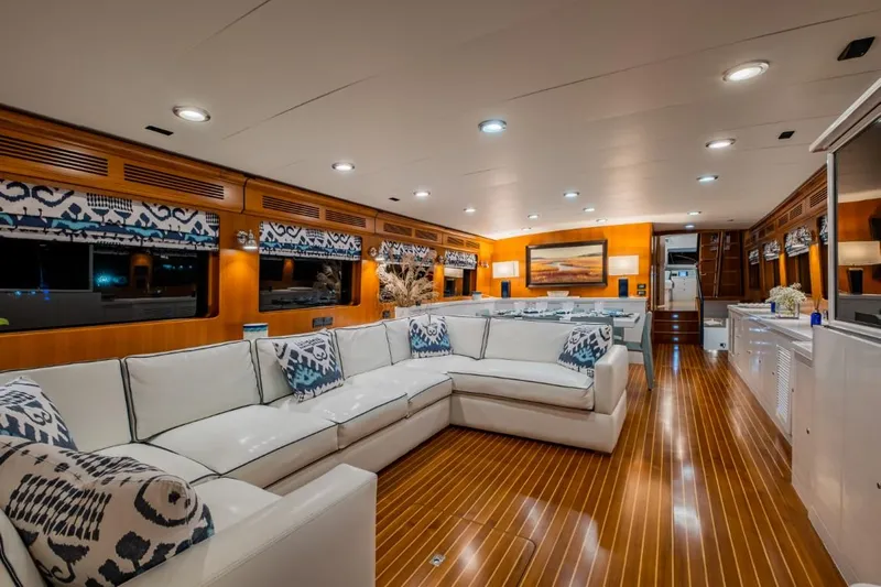Pivot Yacht Photos Pics Luxurious interior of 2013 Marlow Explorer Enclosed Bridge (CB) yacht with white sectional sofa.